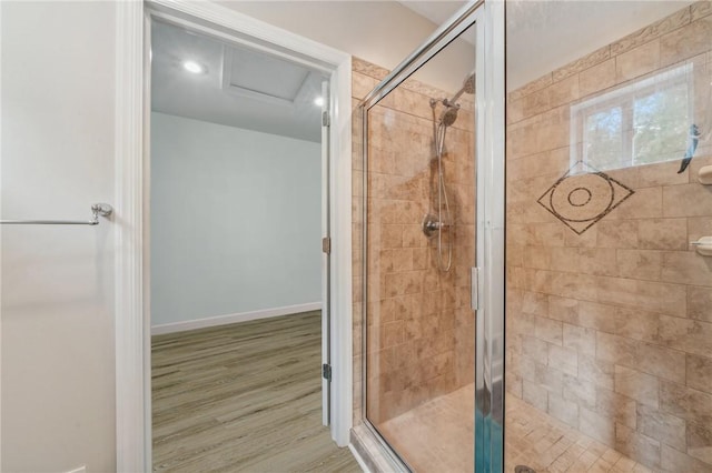 bathroom with hardwood / wood-style flooring and walk in shower