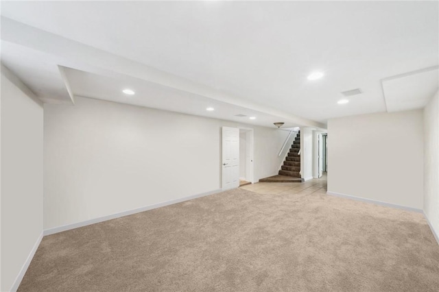 basement featuring light carpet