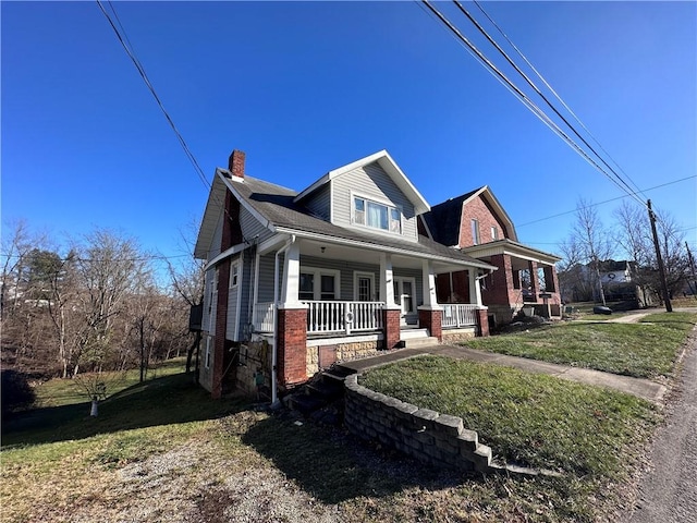 view of front of property with a porch and a front lawn