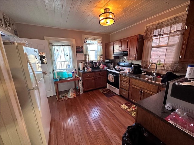 kitchen with stainless steel refrigerator, white gas stove, sink, dark wood-type flooring, and wood ceiling