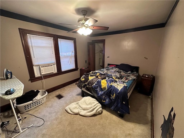 carpeted bedroom with ceiling fan, cooling unit, and ornamental molding