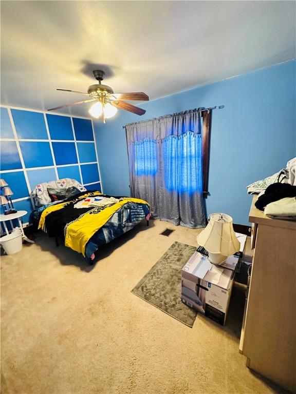 bedroom with light colored carpet and ceiling fan