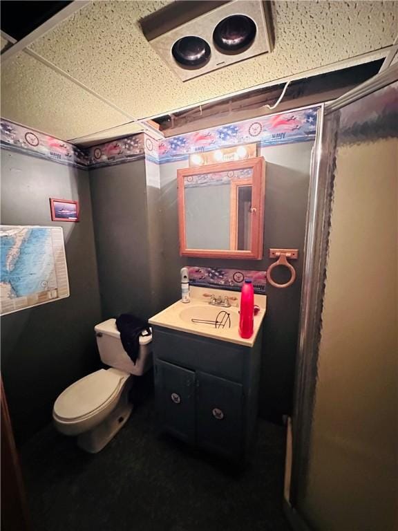 bathroom with a paneled ceiling, vanity, and toilet