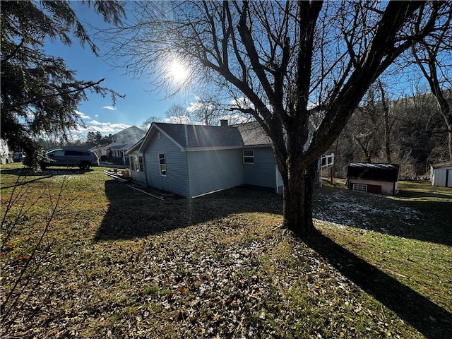 exterior space with a yard and a storage shed