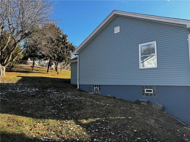 view of side of home featuring a yard