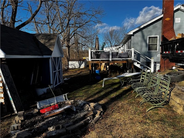 view of yard with a storage shed and a wooden deck