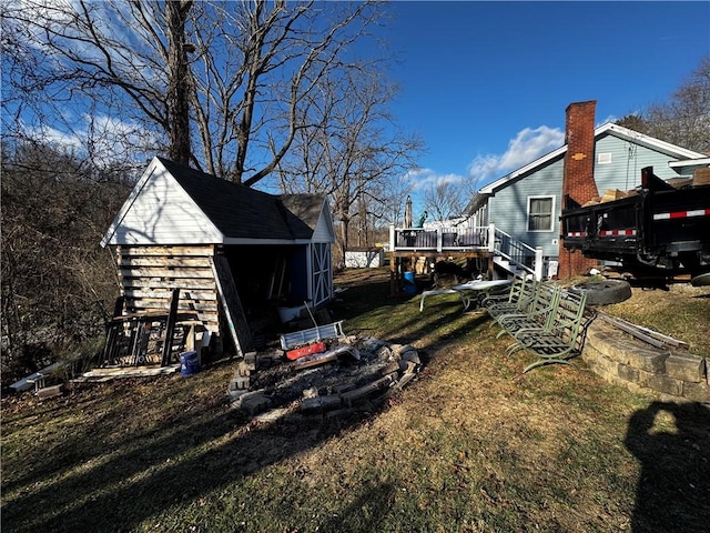 view of yard with a deck and a storage unit