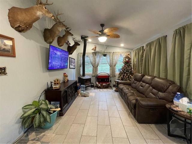 living room featuring ceiling fan and lofted ceiling