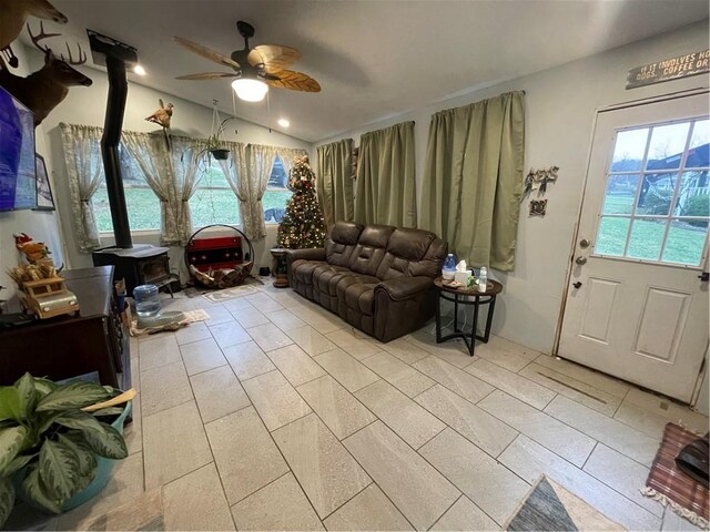 living room featuring ceiling fan and lofted ceiling