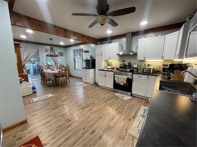 kitchen featuring white cabinetry, sink, wall chimney exhaust hood, stainless steel appliances, and light hardwood / wood-style flooring