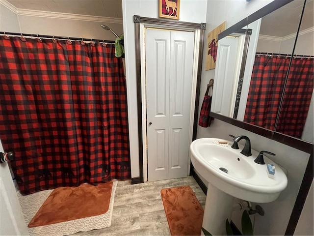 bathroom with crown molding and walk in shower