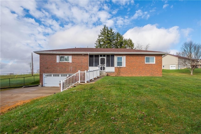 view of front of house featuring a sunroom, a garage, and a front yard