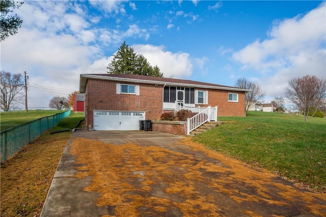 view of front of property featuring a garage and a front lawn