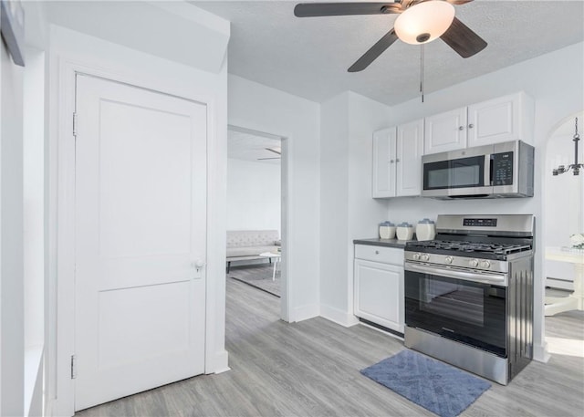 kitchen with white cabinetry, ceiling fan, light wood-type flooring, and appliances with stainless steel finishes