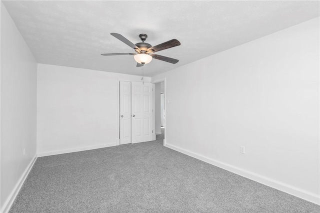 carpeted empty room featuring ceiling fan