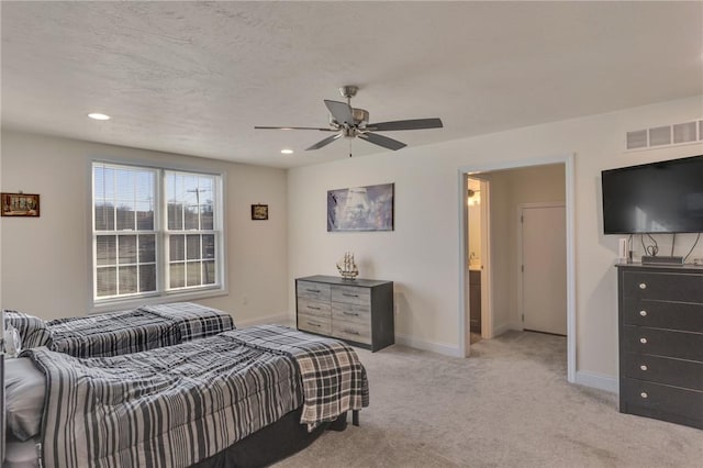 carpeted bedroom featuring ceiling fan and connected bathroom