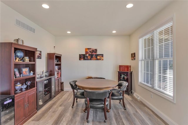 dining area featuring light wood-type flooring and wine cooler