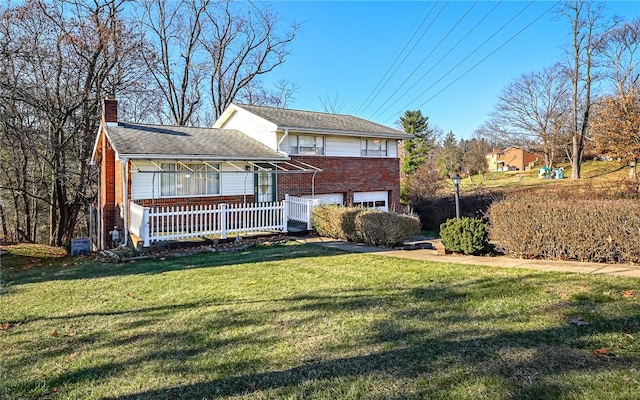 view of front of property with a front lawn and a garage