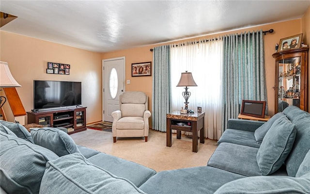 carpeted living room with a healthy amount of sunlight