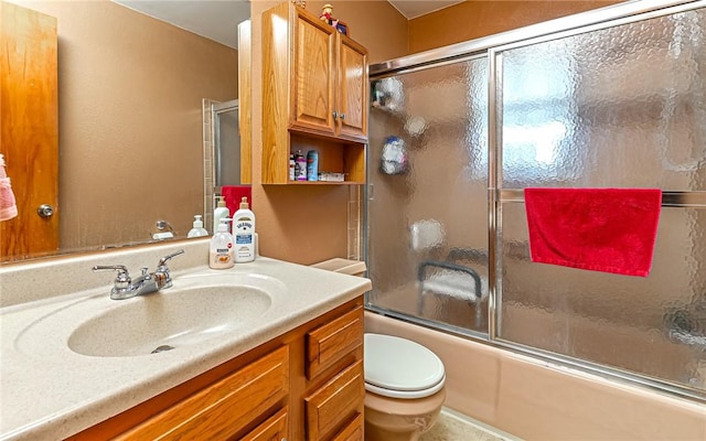 full bathroom with toilet, vanity, and combined bath / shower with glass door