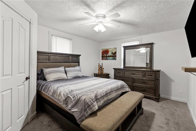 bedroom featuring light carpet, a textured ceiling, and ceiling fan