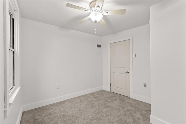 spare room featuring ceiling fan and light colored carpet