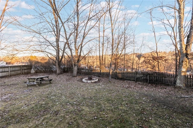view of yard with an outdoor fire pit and a fenced backyard