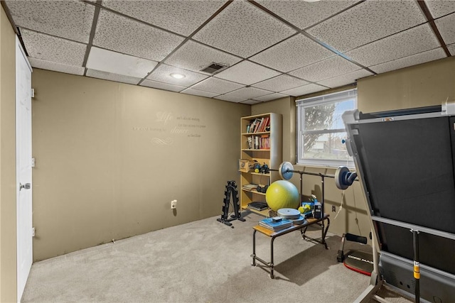 exercise area with visible vents, a drop ceiling, and carpet