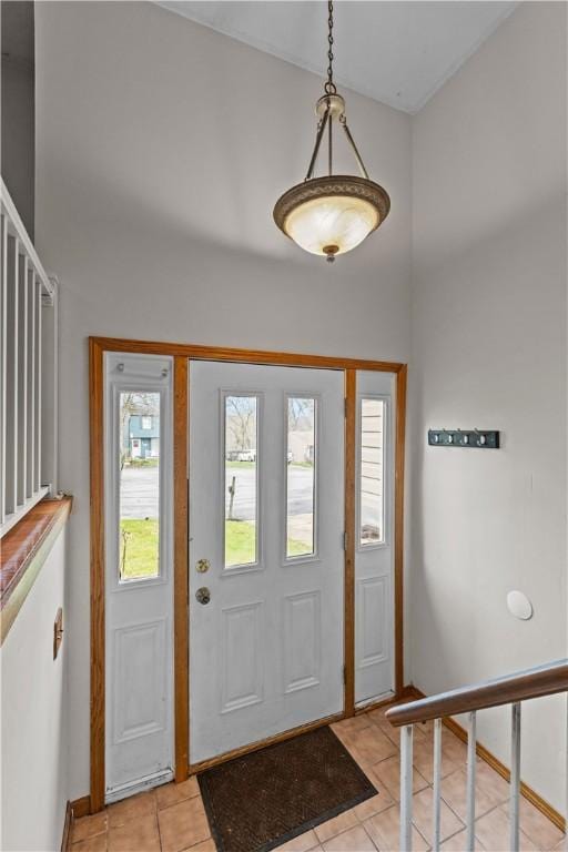 entryway with a high ceiling and light tile patterned floors