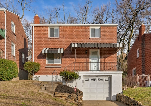 view of front of property featuring an attached garage, a chimney, concrete driveway, and brick siding