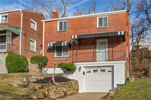 view of front of property with concrete driveway, brick siding, a chimney, and an attached garage