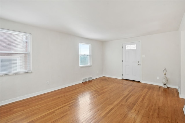 interior space featuring light wood finished floors, visible vents, and baseboards