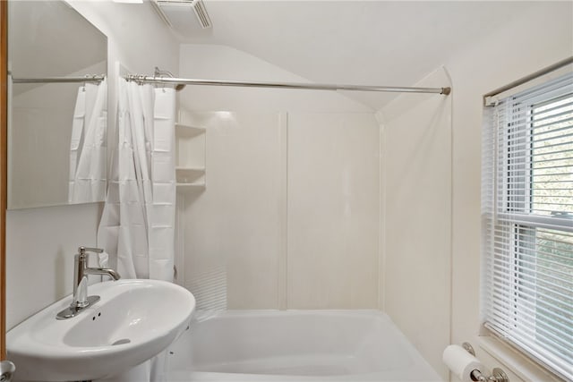 bathroom featuring shower / bath combo and a sink