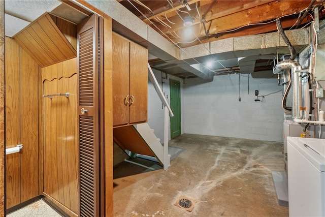 unfinished basement featuring washer / dryer