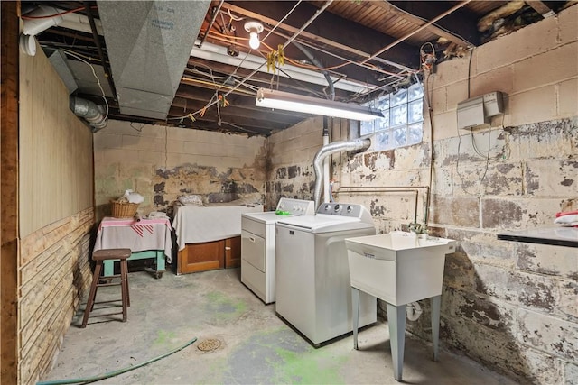 washroom featuring washer and dryer and sink