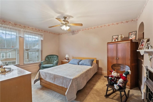 bedroom featuring light carpet and ceiling fan