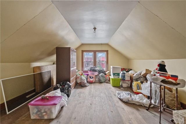 bonus room with hardwood / wood-style flooring and lofted ceiling