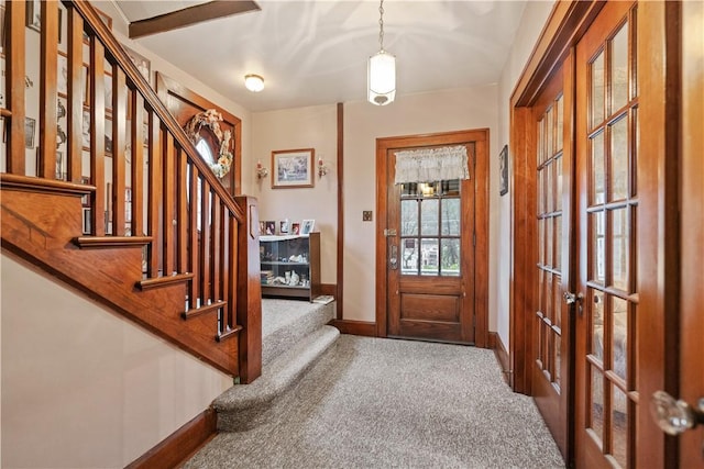 carpeted foyer featuring french doors