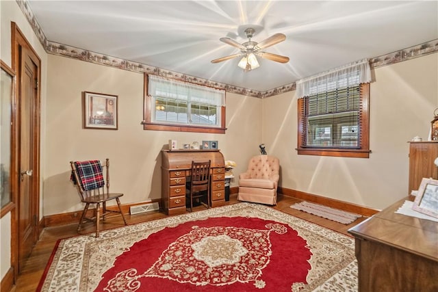 living area with ceiling fan and hardwood / wood-style flooring