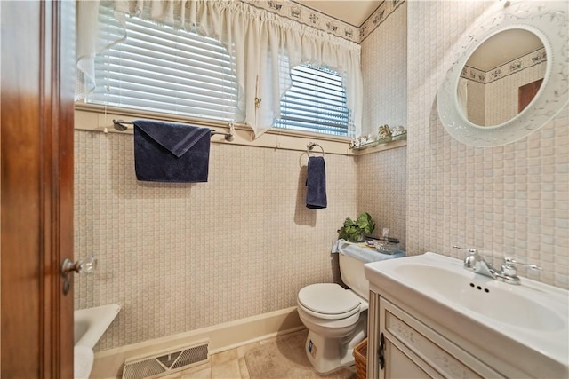 bathroom featuring tile patterned floors, vanity, and toilet