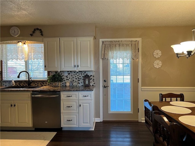 kitchen featuring dark wood-type flooring, stainless steel dishwasher, a healthy amount of sunlight, and sink