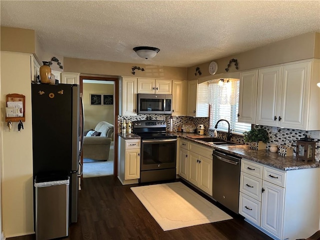 kitchen featuring white cabinetry, sink, appliances with stainless steel finishes, and dark wood-type flooring