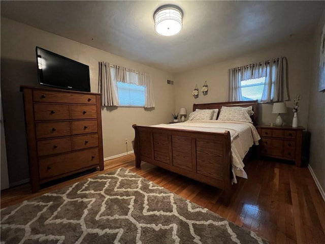 bedroom with dark wood-type flooring