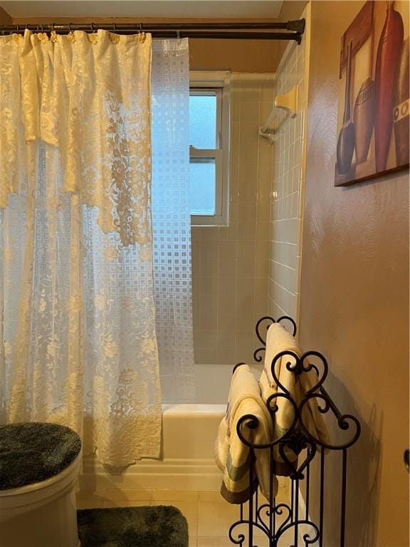 bathroom featuring toilet, tile patterned floors, and shower / bathtub combination with curtain