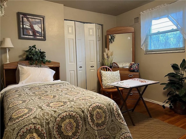 bedroom with a closet and hardwood / wood-style floors