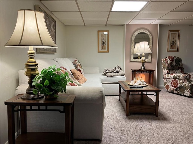 carpeted living room with a paneled ceiling