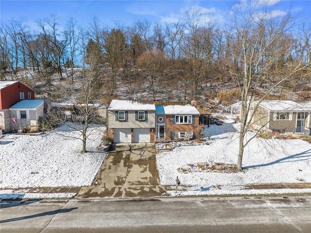 view of front of home featuring concrete driveway and an attached garage