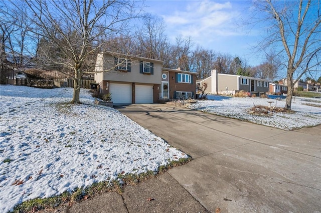 view of front facade with brick siding, driveway, and an attached garage