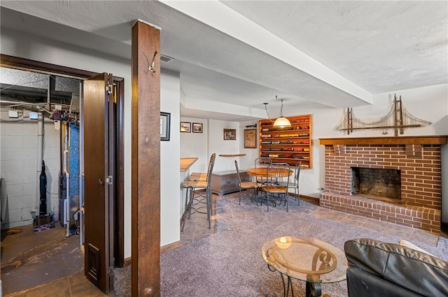 living room with a fireplace and a textured ceiling