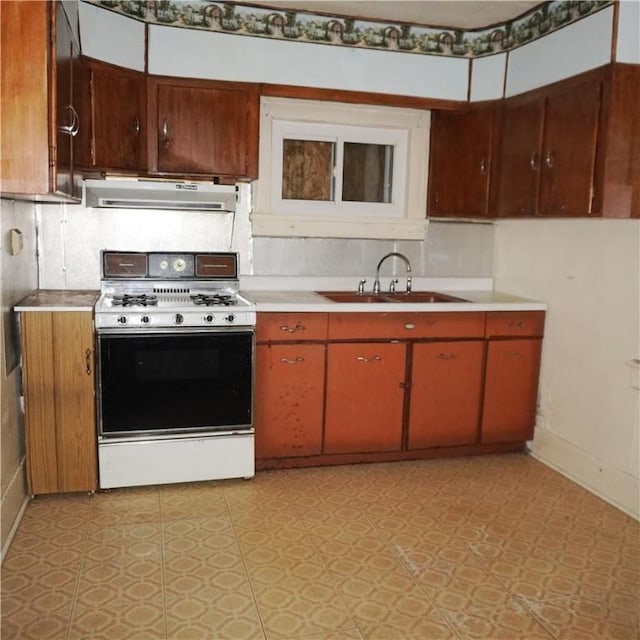 kitchen featuring white gas stove and sink